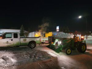Earth Smart Property Solutions clearing snow on commercial property