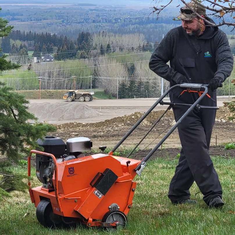 Lawn aeration equipment in use, demonstrating additional services offered alongside fertilization